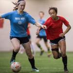 Iced Out, blue, competes against Naughty List, red, in the finals of the high school division at the annual Holiday Cup Soccer Tournament at the Wells Fargo Dimond Park Field House on Monday, Dec. 31, 2018. Iced Out won 8-2. (Michael Penn | Juneau Empire)