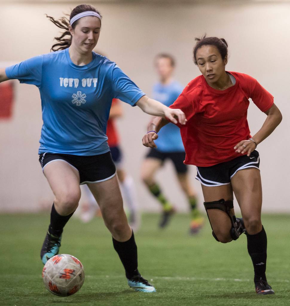 Iced Out, blue, competes against Naughty List, red, in the finals of the high school division at the annual Holiday Cup Soccer Tournament at the Wells Fargo Dimond Park Field House on Monday, Dec. 31, 2018. Iced Out won 8-2. (Michael Penn | Juneau Empire)