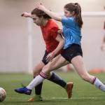 Iced Out, blue, competes against Naughty List, red, in the finals of the high school division at the annual Holiday Cup Soccer Tournament at the Wells Fargo Dimond Park Field House on Monday, Dec. 31, 2018. Iced Out won 8-2. (Michael Penn | Juneau Empire)