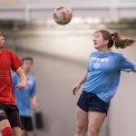 Iced Out, blue, competes against Naughty List, red, in the finals of the high school division at the annual Holiday Cup Soccer Tournament at the Wells Fargo Dimond Park Field House on Monday, Dec. 31, 2018. Iced Out won 8-2. (Michael Penn | Juneau Empire)