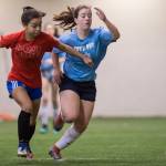 Iced Out, blue, competes against Naughty List, red, in the finals of the high school division at the annual Holiday Cup Soccer Tournament at the Wells Fargo Dimond Park Field House on Monday, Dec. 31, 2018. Iced Out won 8-2. (Michael Penn | Juneau Empire)