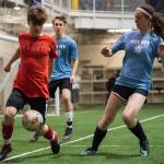 Iced Out, blue, competes against Naughty List, red, in the finals of the high school division at the annual Holiday Cup Soccer Tournament at the Wells Fargo Dimond Park Field House on Monday, Dec. 31, 2018. Iced Out won 8-2. (Michael Penn | Juneau Empire)