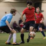 Iced Out, blue, competes against Naughty List, red, in the finals of the high school division at the annual Holiday Cup Soccer Tournament at the Wells Fargo Dimond Park Field House on Monday, Dec. 31, 2018. Iced Out won 8-2. (Michael Penn | Juneau Empire)