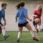 Iced Out, blue, competes against Naughty List, red, in the finals of the high school division at the annual Holiday Cup Soccer Tournament at the Wells Fargo Dimond Park Field House on Monday, Dec. 31, 2018. Iced Out won 8-2. (Michael Penn | Juneau Empire)