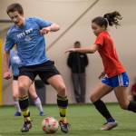 Iced Out, blue, competes against Naughty List, red, in the finals of the high school division at the annual Holiday Cup Soccer Tournament at the Wells Fargo Dimond Park Field House on Monday, Dec. 31, 2018. Iced Out won 8-2. (Michael Penn | Juneau Empire)