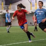Iced Out, blue, competes against Naughty List, red, in the finals of the high school division at the annual Holiday Cup Soccer Tournament at the Wells Fargo Dimond Park Field House on Monday, Dec. 31, 2018. Iced Out won 8-2. (Michael Penn | Juneau Empire)
