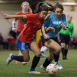 Iced Outs Brianna Jokerst competes against Naughty Lists Blake Plummer in the finals of the high school division at the annual Holiday Cup Soccer Tournament at the Wells Fargo Dimond Park Field House on Monday, Dec. 31, 2018. Iced Out won 8-2. (Michael Penn | Juneau Empire)