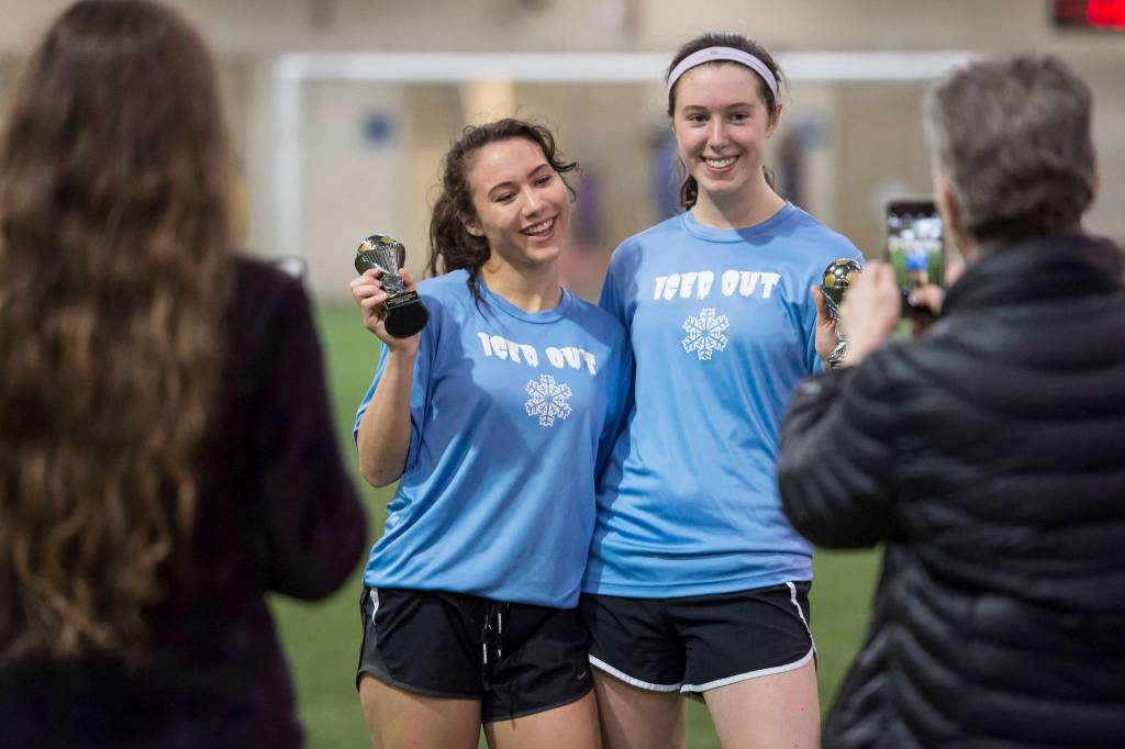 Iced Out, blue, competes against Naughty List, red, in the finals of the high school division at the annual Holiday Cup Soccer Tournament at the Wells Fargo Dimond Park Field House on Monday, Dec. 31, 2018. Iced Out won 8-2. (Michael Penn | Juneau Empire)