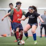 Grinch Gang, red, competes against Black Ice, black, in the finals of the senior division at the annual Holiday Cup Soccer Tournament at the Wells Fargo Dimond Park Field House on Monday, Dec. 31, 2018. The Grinch Gang won 8-2. (Michael Penn | Juneau Empire)
