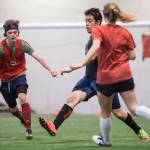 Grinch Gang, red, competes against Black Ice, black, in the finals of the senior division at the annual Holiday Cup Soccer Tournament at the Wells Fargo Dimond Park Field House on Monday, Dec. 31, 2018. The Grinch Gang won 8-2. (Michael Penn | Juneau Empire)