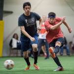 Grinch Gang, red, competes against Black Ice, black, in the finals of the senior division at the annual Holiday Cup Soccer Tournament at the Wells Fargo Dimond Park Field House on Monday, Dec. 31, 2018. The Grinch Gang won 8-2. (Michael Penn | Juneau Empire)