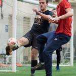 Grinch Gang, red, competes against Black Ice, black, in the finals of the senior division at the annual Holiday Cup Soccer Tournament at the Wells Fargo Dimond Park Field House on Monday, Dec. 31, 2018. The Grinch Gang won 8-2. (Michael Penn | Juneau Empire)