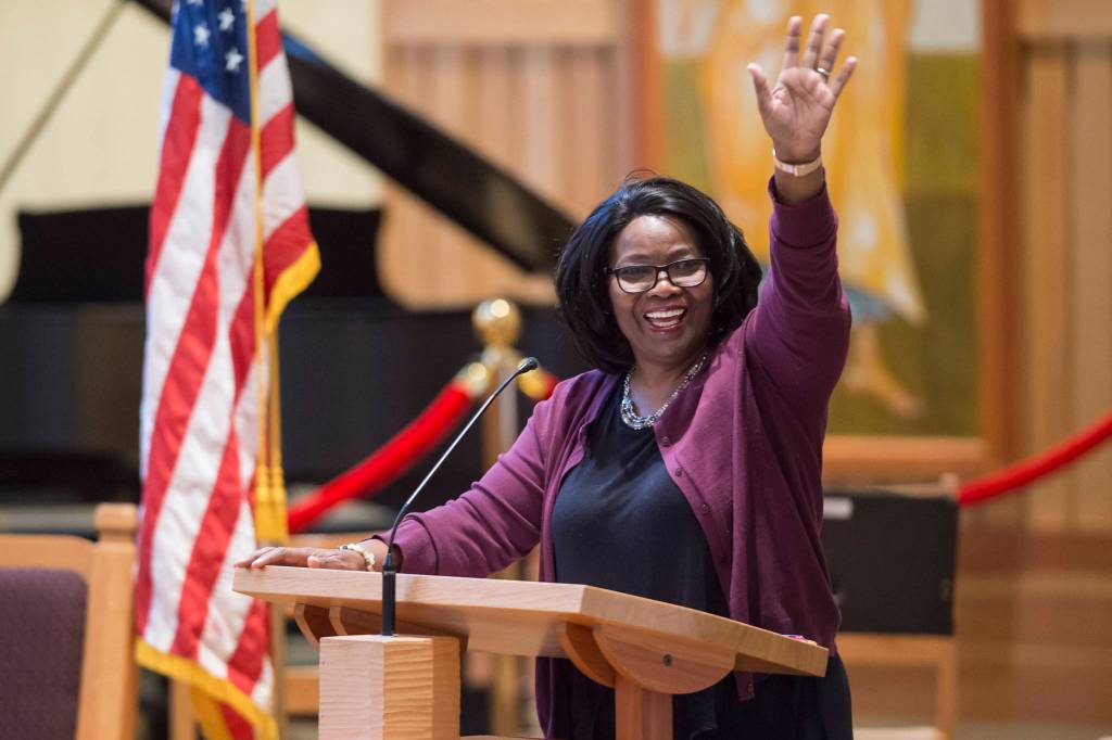 Speaker Michelle Monts, a former president of the Black Awareness Association, waves to her grandchildren in the audience at the Dr. Martin Luther King Jr. 2019 Community Celebration at St. Pauls Catholic Church on Monday, Jan. 21, 2019. (Michael Penn | Juneau Empire)