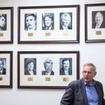 Former Speaker of the House Bryce Edgmon, D-Dillingham, is interviewed in front of pictures of former Speakers at the Capitol on Wednesday, Jan. 16, 2019. (Michael Penn | Juneau Empire)