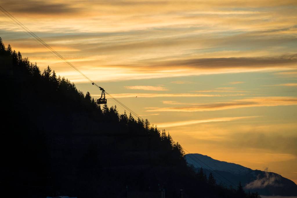A Mt. Roberts Tramway car descends against a colorful surnise on Wednesday, Jan. 16, 2019. (Michael Penn | Juneau Empire)