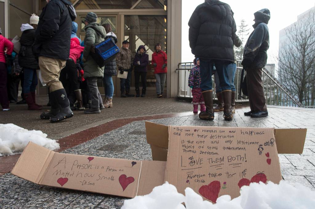 Signs left on the sideway after the Alaskans for Life, Inc. annual Rally for Life in front of the Capitol on Tuesday, Jan. 22, 2019. (Michael Penn | Juneau Empire)