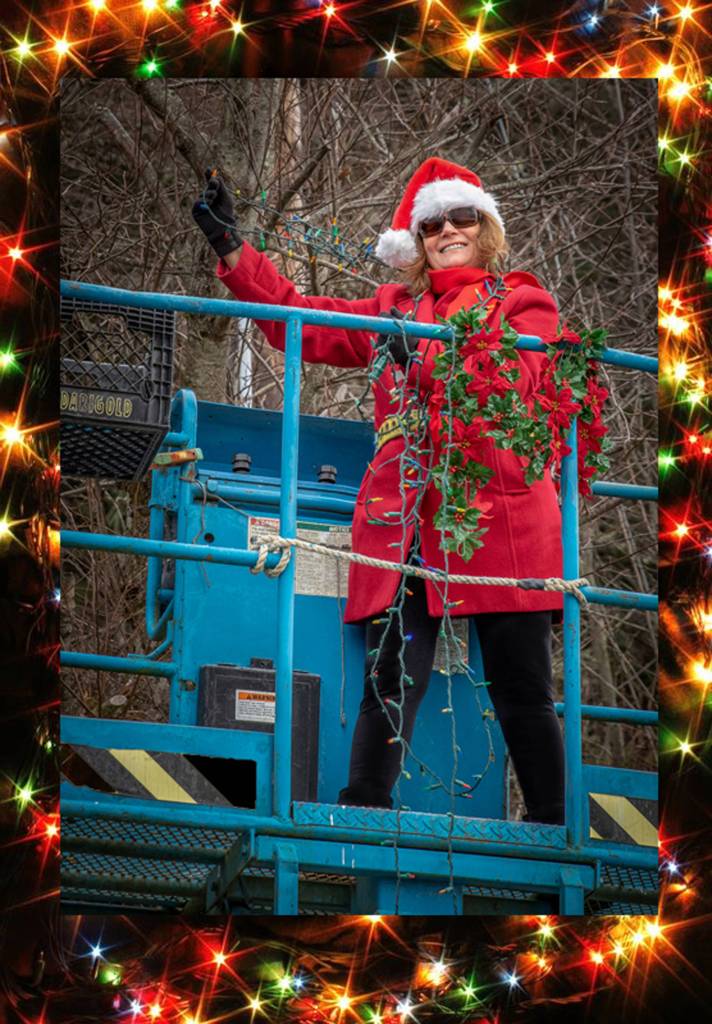 Dec. 23, 2018: Tis the season to enjoy the holidays in style. As part of an annual decorating tradition, Santas helper Mary Siroky recently assisted in hanging holiday lights at the Gitkov dock in Auke Bay. Her stylish outfit includes a requisite Santas hat, red jacket, red scarf and black pants and boots. And although her clothes were not tarnished with ashes or soot, she was wearing her requisite OSHA safety belt as she was hoisted into the air.