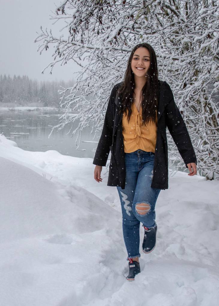 Jan. 27, 2019: On a snowy morning near the Mendenhall River, Taylor Baker was a definite bright spot. Her gold blouse from H&M, distressed jeans from Apricot Lane and black trench coat from Be Cool LA really stood out against the otherwise white landscape. I also loved the navy low-cut Xtratufs that she borrowed from her boyfriend Andy  practical and attractive!