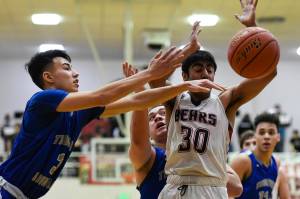 Thunder Mountains Bryson Echiverri, left, and Puna Toutaiolepo, center, strip the ball from Juneau-Douglas Krishant Samtani at JDHS on Friday, Jan. 25, 2019. Thunder Mountain won 67-63. (Michael Penn | Juneau Empire)