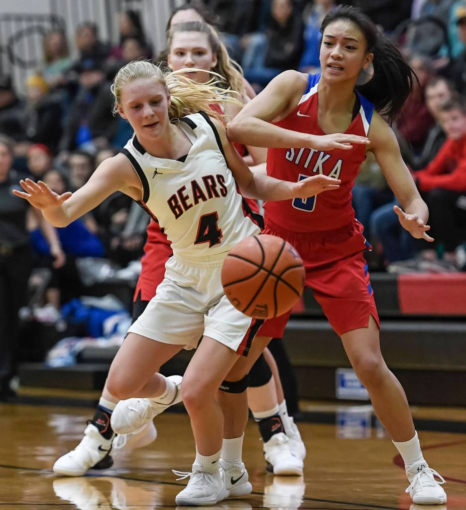 Juneau-Douglas Sadie Tuckwood, left,and Sitkas Shaye Jensen go after a loose ball at JDHS on Friday, Jan. 25, 2019. Sitka won 37-31. (Michael Penn | Juneau Empire)
