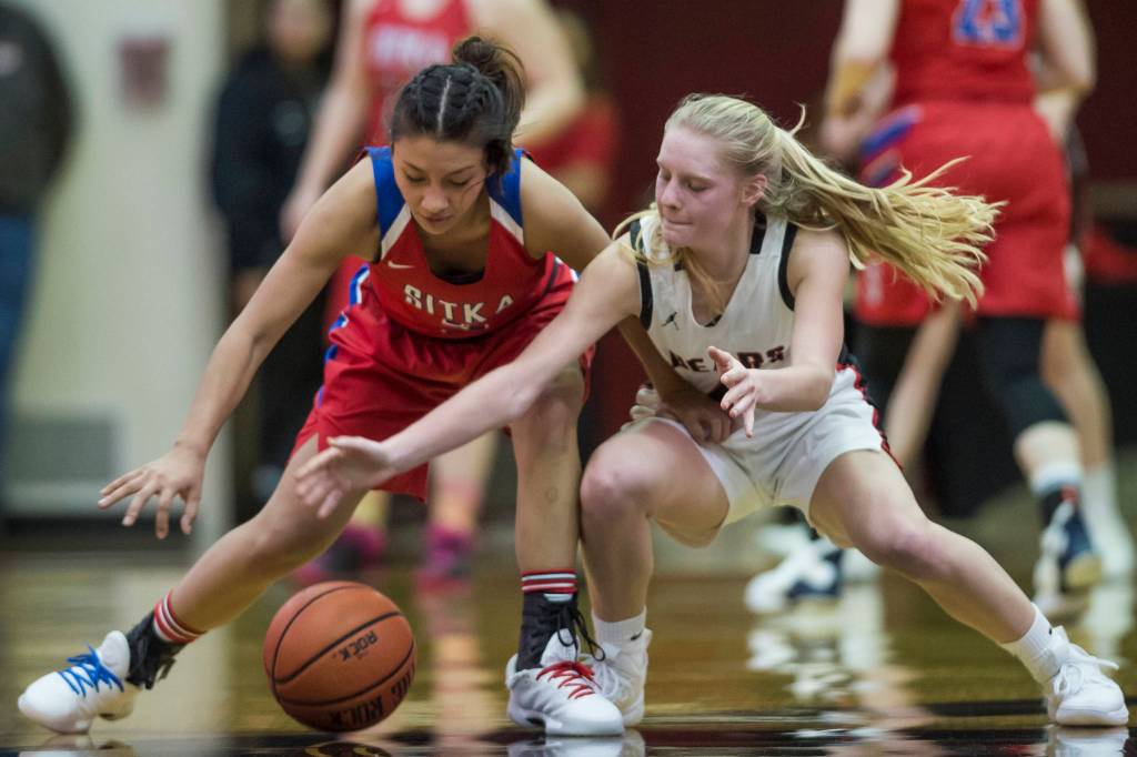 Juneau-Douglas Sadie Tuckwood, right, attempts a steal against Sitkas Tiffany Elefante at JDHS on Friday, Jan. 25, 2019. Sitka won 37-31. (Michael Penn | Juneau Empire)