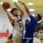 Juneau-Douglas Philip Gonzales, left, shoots against Thunder Mountains Brady Carandang at JDHS on Friday, Jan. 25, 2019. Thunder Mountain won 67-63. (Michael Penn | Juneau Empire)