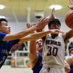 Thunder Mountains Bryson Echiverri, left, and Vaipuna Toutaiolepo, center, strip the ball from Juneau-Douglas Krishant Samtani at JDHS on Friday, Jan. 25, 2019. Thunder Mountain won 67-63. (Michael Penn | Juneau Empire)