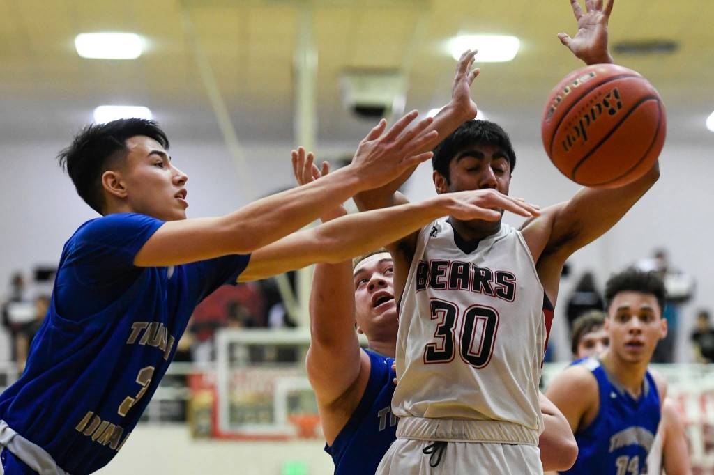 Thunder Mountains Bryson Echiverri, left, and Vaipuna Toutaiolepo, center, strip the ball from Juneau-Douglas Krishant Samtani at JDHS on Friday, Jan. 25, 2019. Thunder Mountain won 67-63. (Michael Penn | Juneau Empire)
