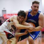 Juneau-Douglas Cooper Kriegmont, left, and Thunder Mountains Vaipuna Toutaiolepo wrestle for the ball at JDHS on Friday, Jan. 25, 2019. Thunder Mountain won 67-63. (Michael Penn | Juneau Empire)