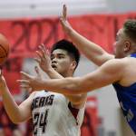 Juneau-Douglas Philip Gonzales, left, is pressured by Thunder Mountains Puna Toutaiolepo at JDHS on Friday, Jan. 25, 2019. After losing on Friday, JDHS won 60-54 on Saturday. (Michael Penn | Juneau Empire File)