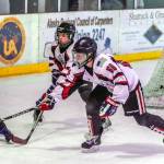 Juneaus Luke Bovitz (68) and Camden Kovach keep Eagle Rivers Adam Kara away from netminder Mason Sooter. (Courtesy Photo | Steve Quinn)