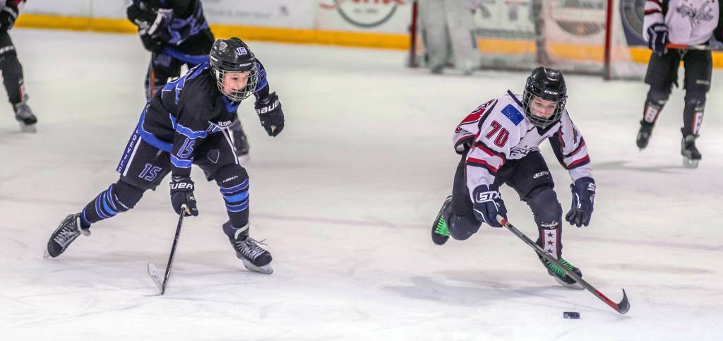 Juneaus Caden Johns, right, looks to evade Eagle Rivers Kaden Lynch during a weekend game at Treadwell Ice Arena. (Courtesy Photo | Steve Quinn)