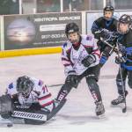 Juneau goalie Caleb Friend covers a puck while teammate Sonny Monsef looks on after losing his stick during a battle in front of the net. (Courtesy Photo | Steve Quinn)