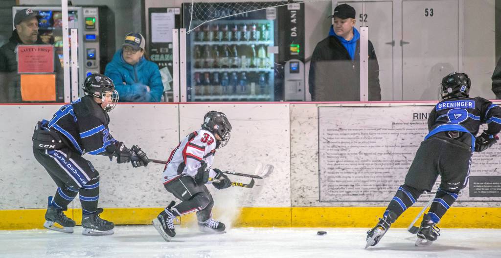 Juneaus Emilio Hollbrook battles for possession in a weekend game versus Eagle River at Treadwell Arena. (Courtesy Photo | Steve Quinn)