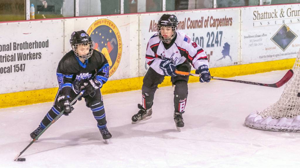 Juneaus Camden Kovach chases down Eagle Rivers Adam Kara during a weekend series at Treadwell Arena. (Courtesy Photo | Steve Quinn)