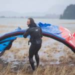 Rob Cadmus drags his kite back to shore after kiteboarding in the Gastineau Channel on Sunday, Dec. 9, 2018. (Nolin Ainsworth | Juneau Empire)