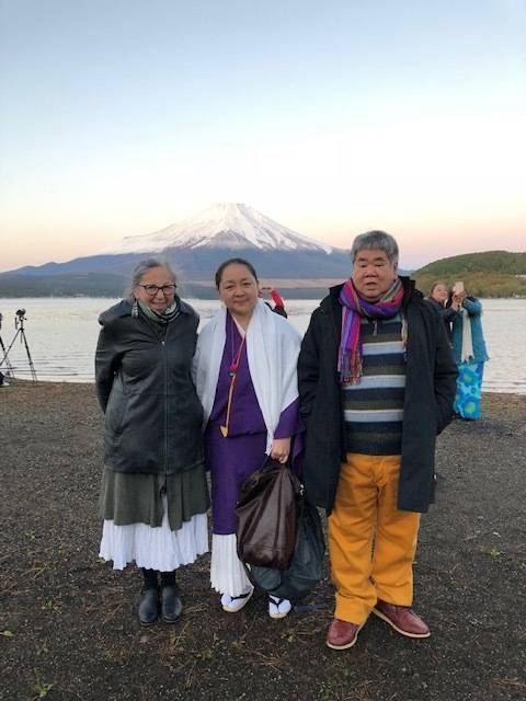 Susan Stark Christianson stands with Rika and Yoshimaru Higa at a gathering of indigenous people in Japan that furthered Christiansons progress on a documentary film. Christianson was able to make the trip thanks to a fellowship award and $18,000 from the Rasmuson Foundation. Christianson was one of several local artists who earned an award and financial support from the foundation in 2018. (Courtesy photo | Susan Stark Christianson)