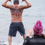 Marvin Pena poses for a picture before taking to the frigid waters at Auke Bay Recreation Area for the annual Juneau Polar Bear Dip on Tuesday, Jan. 1, 2019. Nearly 200 people took the plunge to start off the new year. (Michael Penn | Juneau Empire)