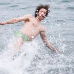 George Kuhar takes a enthusiastic plunge into the frigid waters at Auke Bay Recreation Area for the annual Juneau Polar Bear Dip on Tuesday, Jan. 1, 2019. Nearly 200 people took the plunge to start off the new year. (Michael Penn | Juneau Empire)