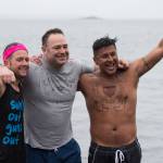 U.S. Coast Guard members John Dale, left, Chris Coutu, center, and Marvin Pena pose for a picture before taking to the frigid waters at Auke Bay Recreation Area for the annual Juneau Polar Bear Dip on Tuesday, Jan. 1, 2019. Nearly 200 people took the plunge to start off the new year. (Michael Penn | Juneau Empire)