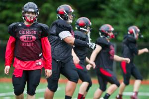 Hunter Hickok leads warmup drills during Juneau-Douglas High School varsity football practice in August of 2015. Hickok was twice named Southeast Conference Defensive Player Of The Year during his time with the Crimson Bears from 2012-2015. (Michael Penn | Juneau Empire File)