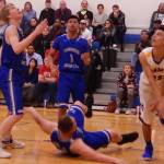 Thunder Mountain teammates Stone Morgan, left; Brady Carandang and Vaipuna Toutaiolepo (down) position themselves for a rebound against Monroe Catholics Mason Muramoto, right, during Mt. McKinley Bank Holiday Classic at Monroe Catholic High School on Thursday, Jan. 3, 2019. (Danny Martin | Fairbanks Daily News Miner)