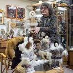 Mary Ellen Frank shows off the work of Saint Lawrence Island artist Anacoma Slwooko at Aunt Claudias Doll Museum during First Friday on Friday, Jan. 4, 2019. (Michael Penn | Juneau Empire)