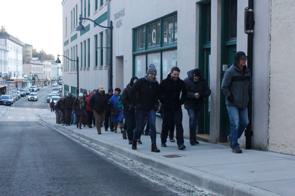 Attendees at a Blueprint Downtown walking tour stride up North Franklin Street on Saturday. (Alex McCarthy | Juneau Empire)