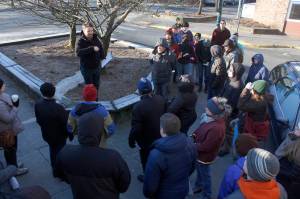 Zane Jones from MRV Architects speaks to attendees at a Blueprint Downtown walking tour on Saturday. Attendees shared their thoughts and experiences about downtown business, housing and public safety. (Alex McCarthy | Juneau Empire)