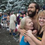 Devin Drones, Diane Bean, left, and Susan James huddle for warmth as they wait the countdown for the annual Polar Bear Dip at Auke Recreation beach on Monday, Jan. 1, 2018.