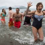 Juneau residents react to the 37 degree water temperature during the annual Polar Bear Dip at Auke Recreation beach on Monday, Jan. 1, 2018.