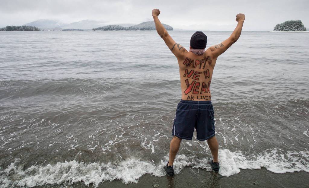 Marvin Pena steels himself for the annual Polar Bear Dip at Auke Recreation beach on Monday, Jan. 1, 2018.