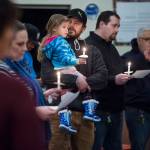 William James Musser V holds his daughter, Annabelle Rose, 4, as they attend a candlelight vigil with about 40 other people at Northern Light United Church on Wednesday, Jan. 10, 2018. The Juneau Reentry Coalition sponsored the event as part of a statewide collaboration remembering people lost to addiction.