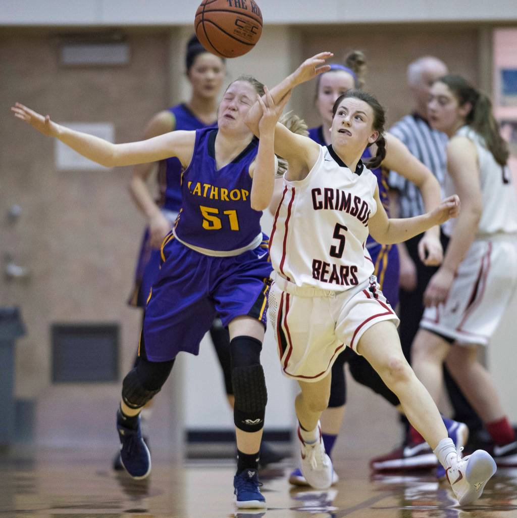 Juneau-Douglas Kiana Potter, right, battles for a loose ball against Lathrops Ella Roberts at JDHS on Friday, Jan. 19, 2018. JDHS won 57-53.
